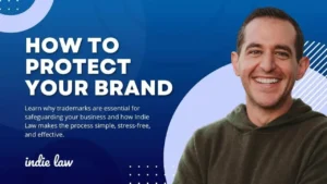 A man smiles beside the text How to Protect Your Brand on a blue background with abstract shapes. Below, smaller text explains the importance of trademarks and how Indie Law helps make the process easy and effective.