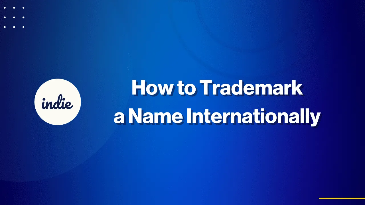 Blue graphic with white text that reads, “How to Trademark a Name Internationally.” On the left, a white circle contains the word “indie” in cursive. The background features abstract blue patterns and white dots in the top left corner.