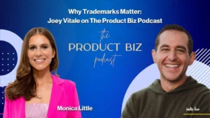 Two smiling people, Monica Little in a pink blazer and Joey Vitale in a green hoodie, are featured on a blue background with the text: Why Trademarks Matter: Joey Vitale on The Product Biz Podcast.