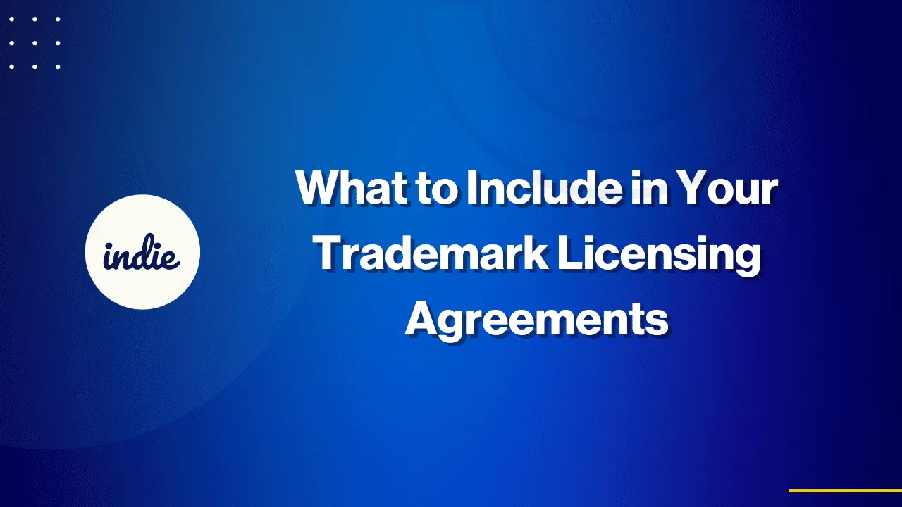 Blue gradient background with white text that reads, What to Include in Your Trademark Licensing Agreements. On the left, a white circle with the word indie inside. Subtle circular graphics and dotted elements decorate the image.