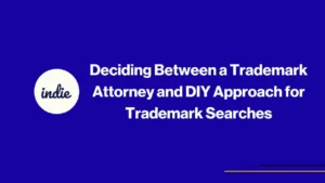 Blue graphic with the word indie in a white circle, next to the text Deciding Between a Trademark Attorney and DIY Approach for Trademark Searches.