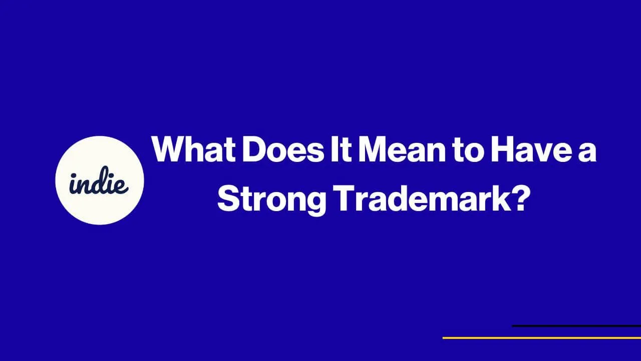 White text on a blue background reads, What Does It Mean to Have a Strong Trademark? A white circle on the left contains the word indie in script. Thin yellow and black lines appear in the lower right corner.