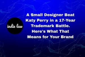 Text reads: "A small designer beat Katy Perry in a 17-year Trademark Battle. Here's what that means for your brand." Indie Law logo on left, blue geometric background.