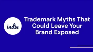Blue background with a white circle on the left containing the word indie. To the right, large white text reads: Trademark Myths That Could Leave Your Brand Exposed. Thin yellow and purple lines are at the bottom right.
