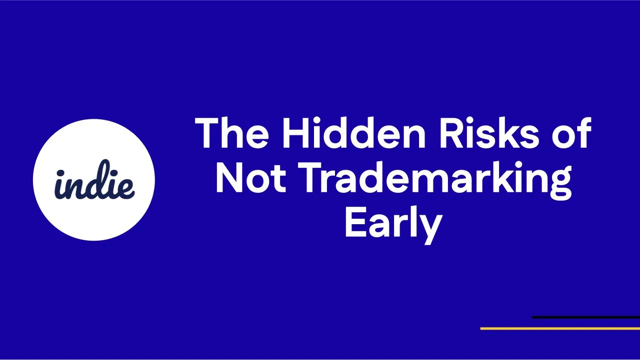 Blue background with white text that reads “The Hidden Risks of Not Trademarking Early.” To the left, a white circle with the word “indie” written inside. Thin yellow and white lines in the bottom right corner.