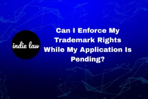 A graphic with the Indie Law logo and the text, "Can I Enforce My Trademark Rights While My Application Is Pending? Learn about trademark application approved next steps," on a blue geometric background.