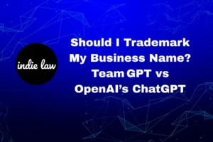 A graphic with the indie law logo and the text: "Should I Trademark My Business Name? Team GPT vs OpenAI’s ChatGPT" on a blue digital background, highlighting key trademark limits businesses should consider.