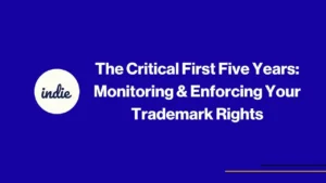 White text on a blue background reads, “The Critical First Five Years: Monitoring & Enforcing Your Trademark Rights.” A white circle on the left contains the word indie in cursive. Two thin yellow and black lines appear in the bottom right corner.