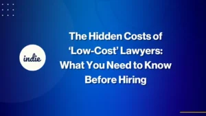 A blue gradient graphic with white text reads: The Hidden Costs of ‘Low-Cost’ Lawyers: What You Need to Know Before Hiring. The indie logo is on the left side.
