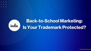 A blue gradient background with the text Back-to-School Marketing: Is Your Trademark Protected? and a white circle on the left with the word indie inside. Small white dots are in the top left corner.