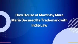 White text on a blue background reads: How House of Martin by Mara Marié Secured Its Trademark with Indie Law. Abstract circular shapes are in the corners.