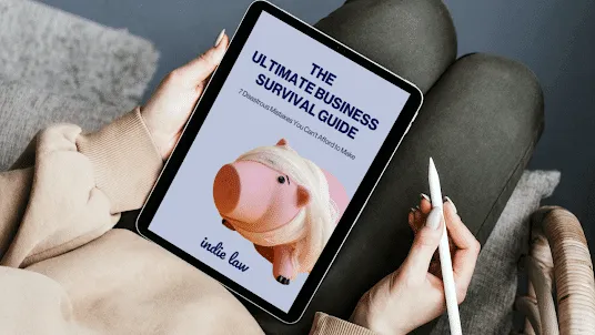 Person holding a tablet displaying a business survival guide cover with a pig illustration and holding a stylus.